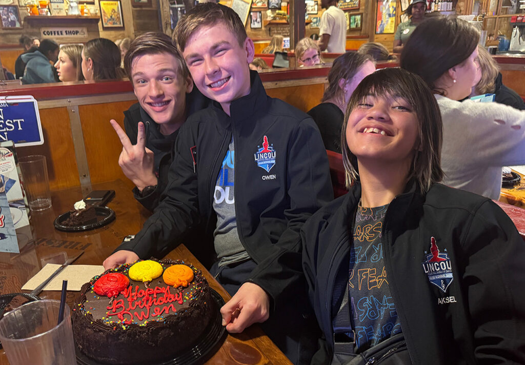 A group of SBNYC students celebrating a birthday while on a trip